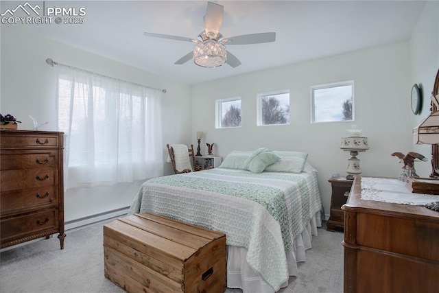 bedroom with ceiling fan, a baseboard radiator, and light colored carpet