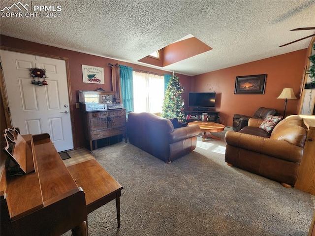 carpeted living room with lofted ceiling with skylight and a textured ceiling