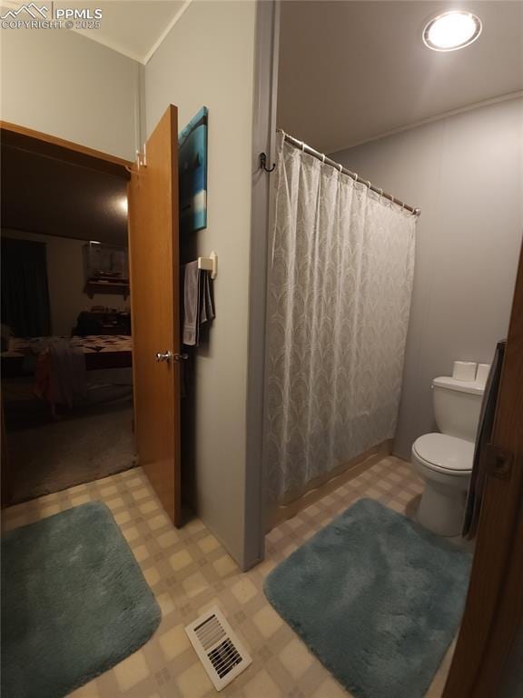 bathroom with toilet and walk in shower