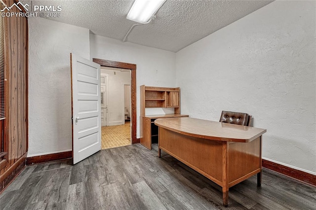 office area featuring dark wood-type flooring and a textured ceiling