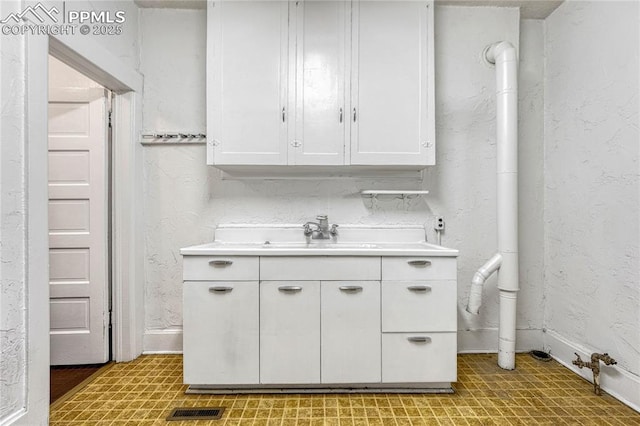 kitchen with sink and white cabinets