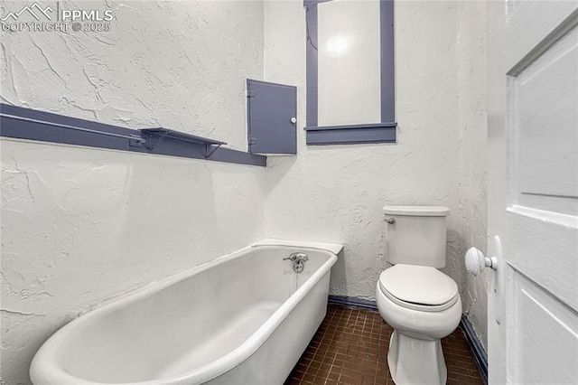 bathroom with tile patterned flooring, a tub to relax in, and toilet