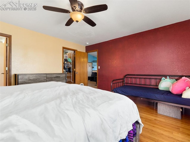 bedroom with hardwood / wood-style floors and ceiling fan