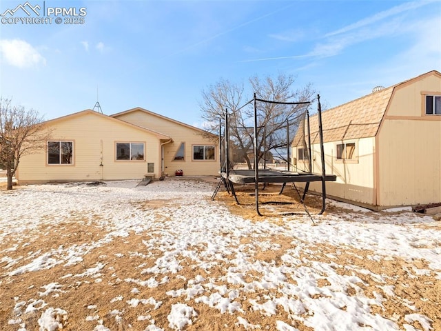 snow covered property featuring a trampoline