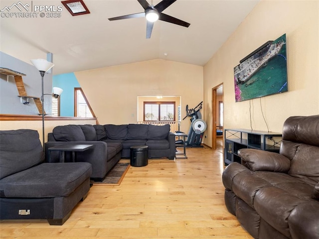 living room with lofted ceiling, light hardwood / wood-style flooring, and ceiling fan