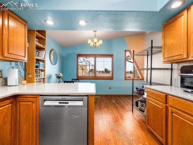 kitchen with decorative light fixtures, light hardwood / wood-style flooring, dishwasher, kitchen peninsula, and a notable chandelier