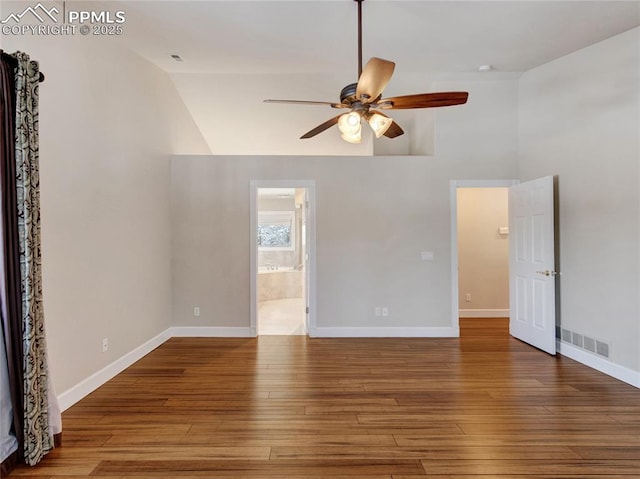 unfurnished room with hardwood / wood-style flooring, lofted ceiling, and ceiling fan