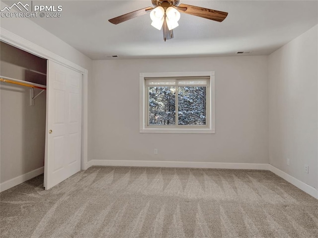 unfurnished bedroom with light colored carpet, a closet, and ceiling fan