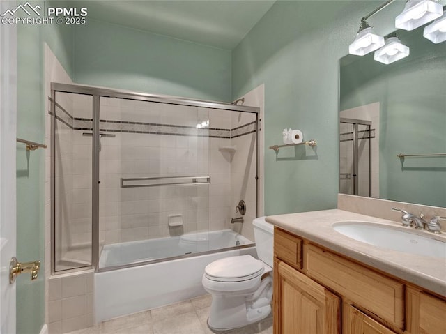 full bathroom with bath / shower combo with glass door, toilet, tile patterned flooring, and vanity