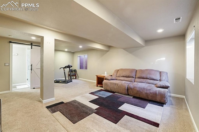 living room with light colored carpet and a barn door