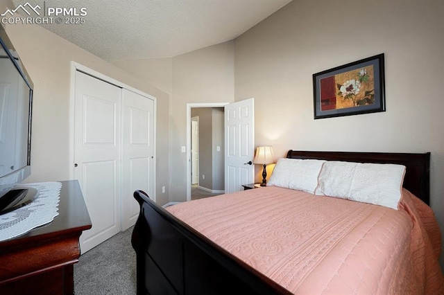 carpeted bedroom featuring vaulted ceiling and a closet