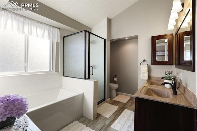 full bathroom featuring vanity, toilet, separate shower and tub, and hardwood / wood-style floors