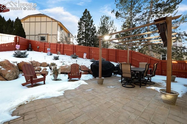 snow covered patio featuring a pergola and grilling area