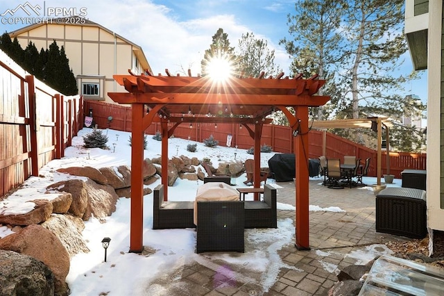 snow covered patio with a grill, an outdoor hangout area, and a pergola