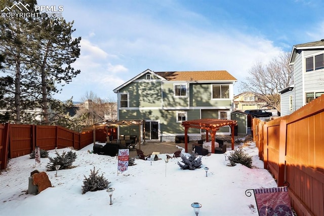 snow covered house featuring a pergola