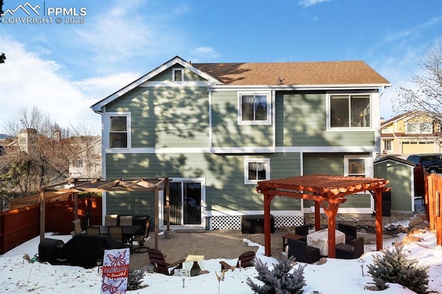 snow covered property featuring a storage shed, an outdoor hangout area, and a pergola