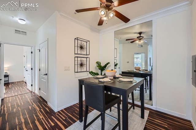 dining space featuring dark hardwood / wood-style flooring and ornamental molding