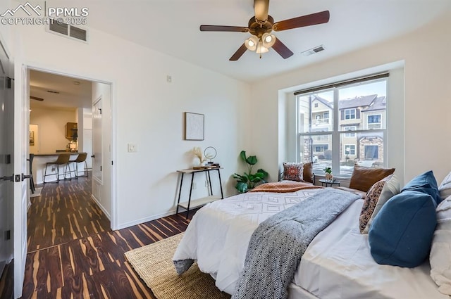 bedroom featuring ceiling fan and dark hardwood / wood-style flooring