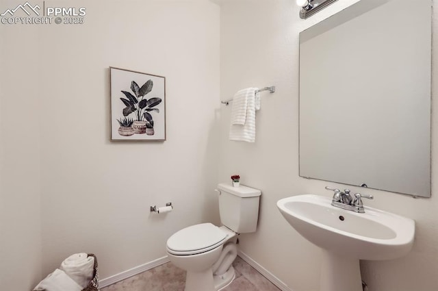 bathroom featuring tile patterned flooring, sink, and toilet