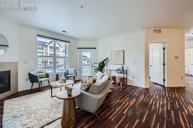 living room featuring ornamental molding, a fireplace, and dark hardwood / wood-style flooring