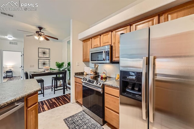 kitchen with ceiling fan and stainless steel appliances