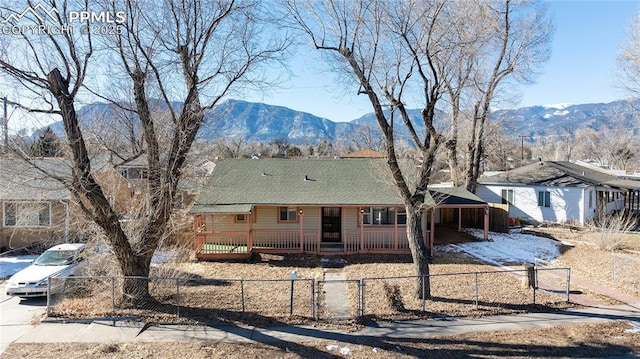 single story home featuring a mountain view and covered porch