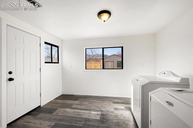 laundry room with dark hardwood / wood-style floors and washer and dryer