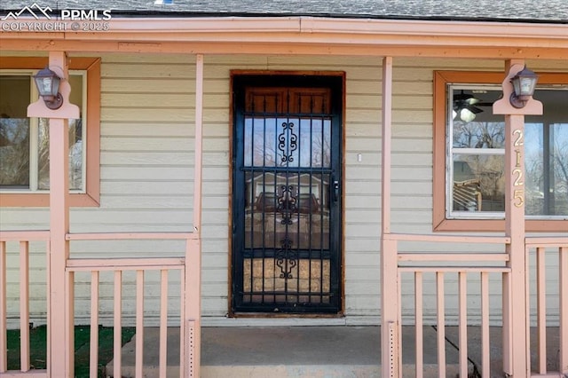 view of exterior entry featuring covered porch