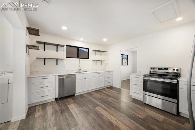 kitchen featuring washer / dryer, sink, dark hardwood / wood-style flooring, stainless steel appliances, and white cabinets