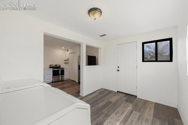 interior space with dark wood-type flooring and washing machine and dryer