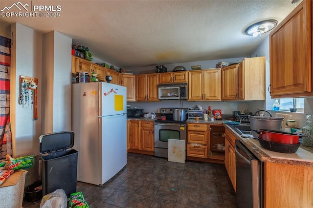 kitchen with stainless steel appliances and a textured ceiling