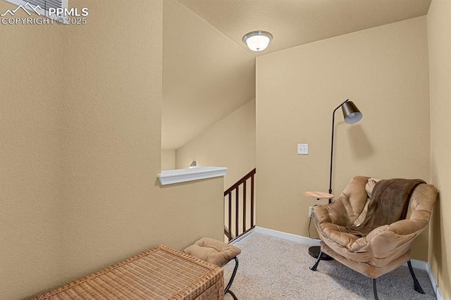 sitting room featuring lofted ceiling and carpet floors