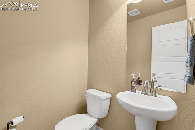 bathroom featuring sink and toilet