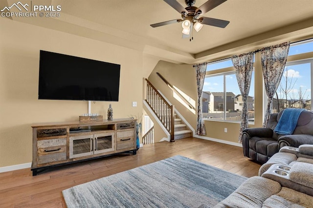 living room with hardwood / wood-style flooring and ceiling fan