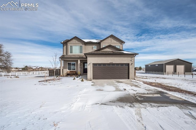 view of front of home featuring an attached garage, fence, driveway, and stucco siding