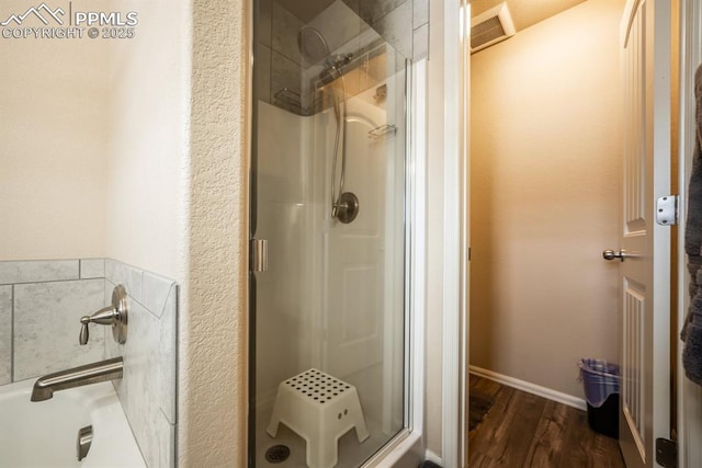 bathroom with hardwood / wood-style flooring and an enclosed shower