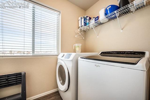 laundry room featuring heating unit, dark hardwood / wood-style flooring, plenty of natural light, and separate washer and dryer