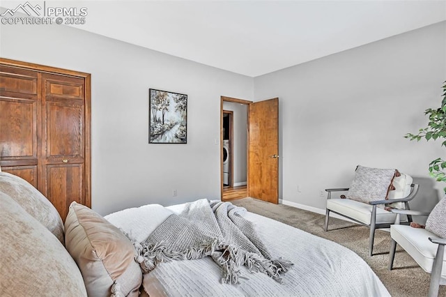 carpeted bedroom featuring washer / clothes dryer