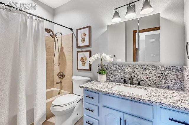 full bathroom featuring shower / bathtub combination with curtain, vanity, and toilet