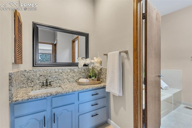 bathroom featuring vanity and a tub