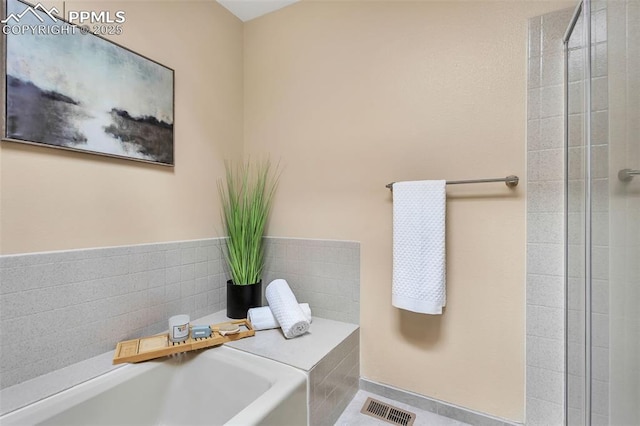 bathroom with tiled bath