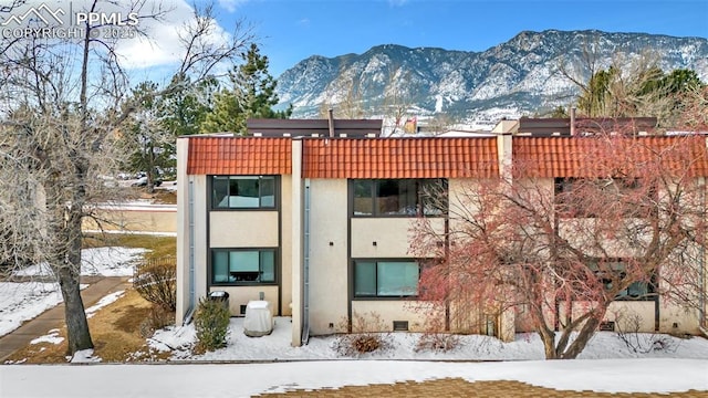 snow covered property featuring a mountain view