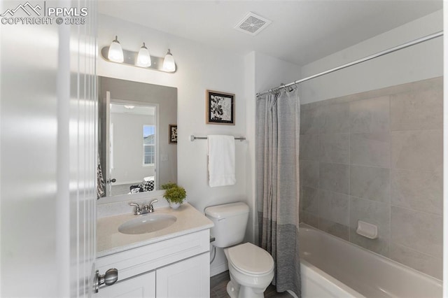 full bathroom with vanity, shower / tub combo with curtain, and toilet