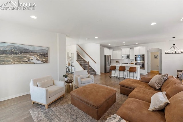 living room featuring a notable chandelier and light hardwood / wood-style floors