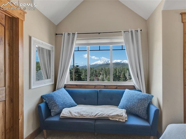 living area with lofted ceiling, baseboards, and a mountain view