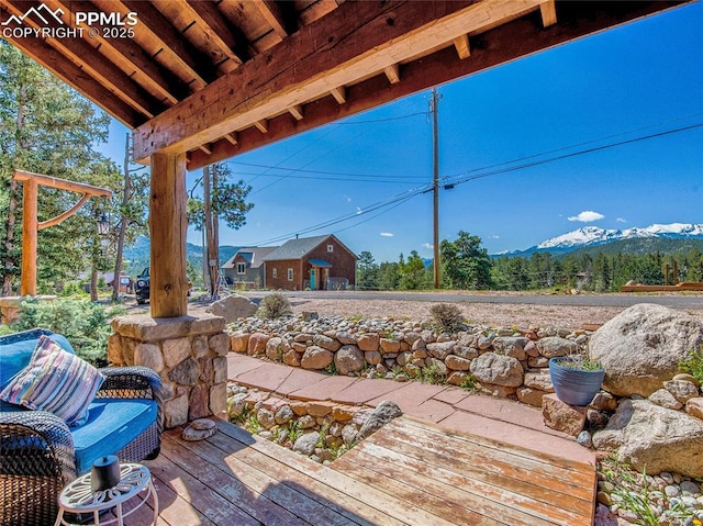 view of patio featuring a deck with mountain view