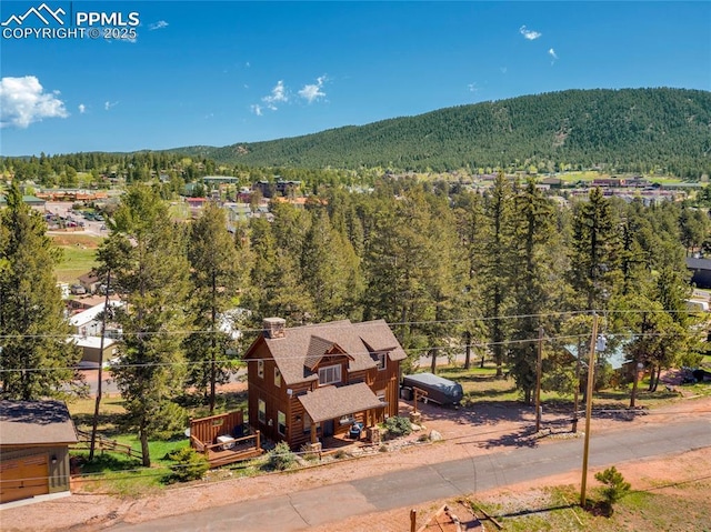 aerial view featuring a mountain view and a view of trees