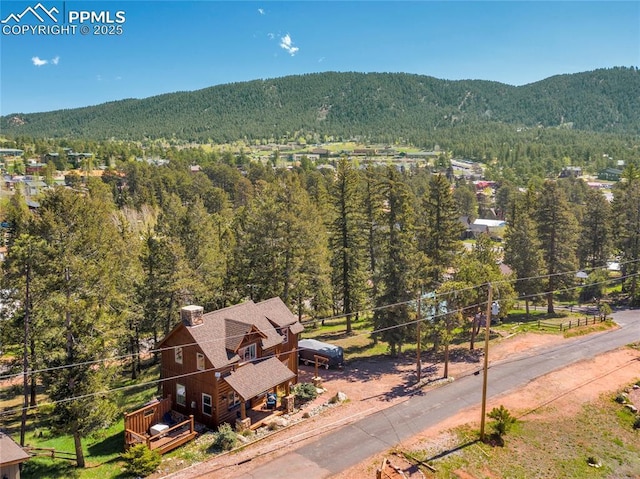 bird's eye view featuring a forest view and a mountain view