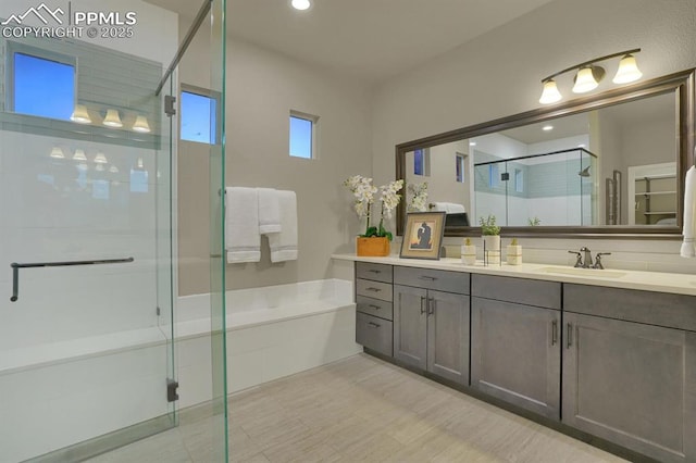 bathroom featuring vanity and a shower with door