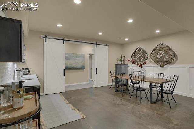 dining room featuring a barn door